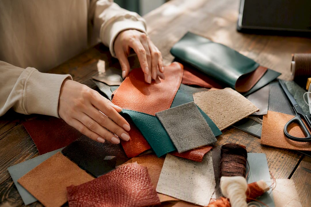 Hands working with vegan leather swatches