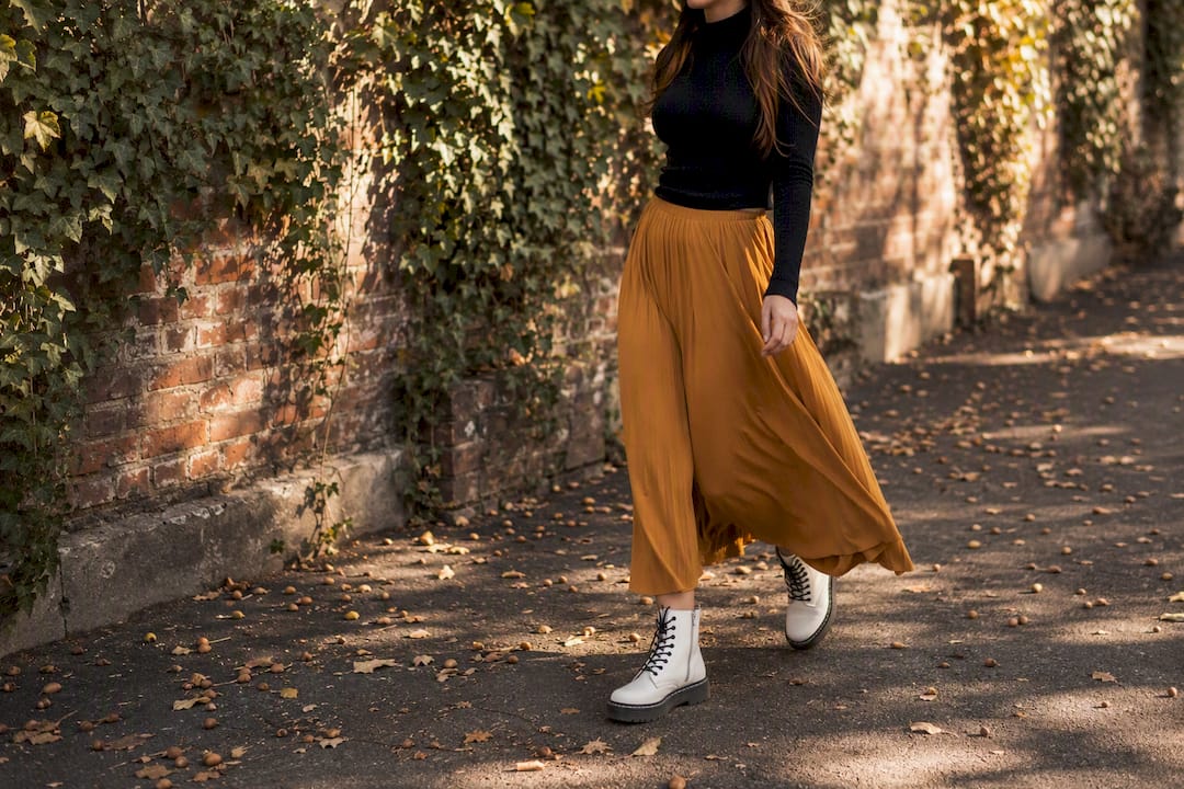 Model walking in white vegan combat boots