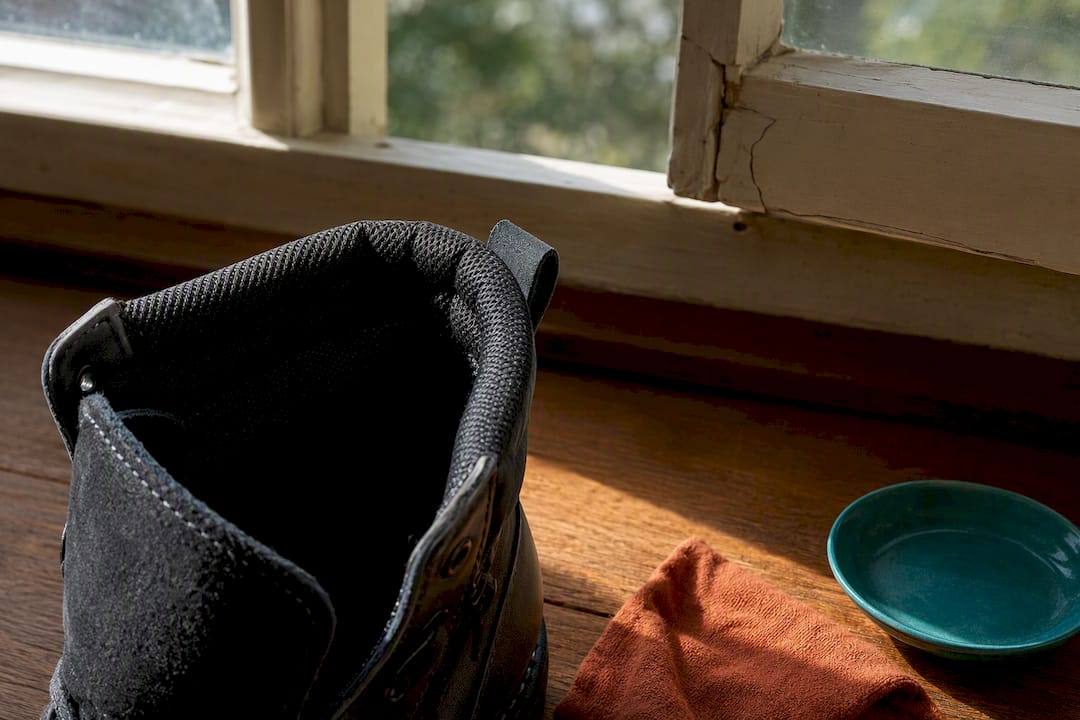 Cropped vegan boot airing beside open window