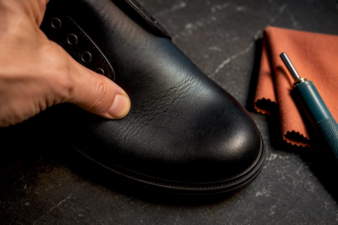 Close-up of vegan boot coating under flex